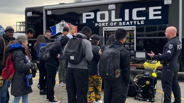 Port police officers give a demo to interested student interns at an intern event.