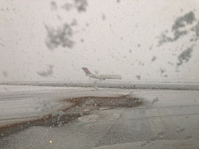 Plane landing at SEA during a snow storm.