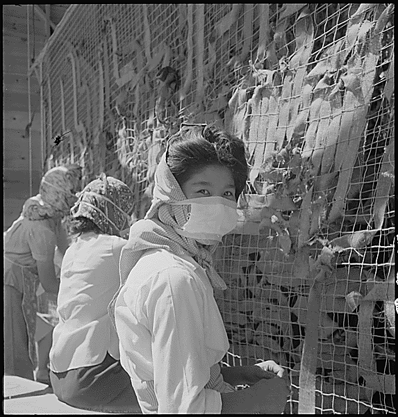 Japanese women working at the camps wearing a mask.