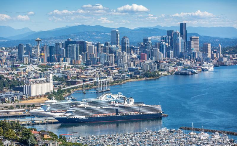 Cruise ship docked with the Seattle skyline in the background.