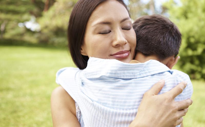 Mother and son hugging