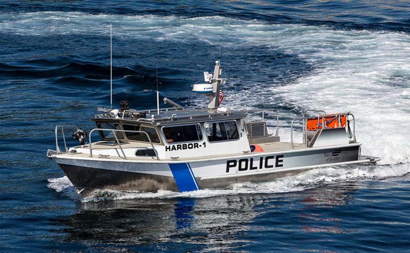 A police boat driving through water.