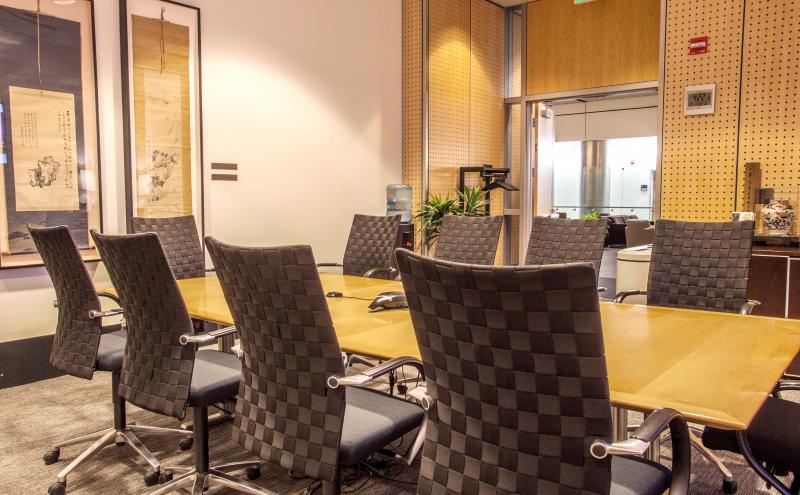 View of the Tokyo boardroom showing the wooden table, with 10 chairs set around the table.