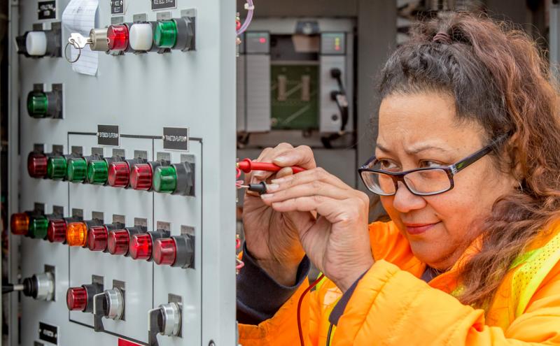 Shannon Acena-Neal inspecting an electrical box.