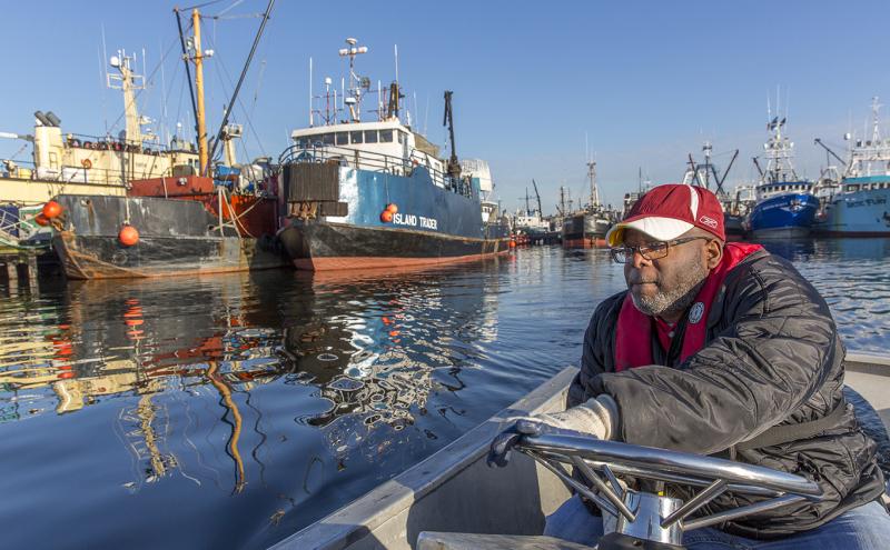 Fisherman guides his skiff between docks at Fishermen't Terminal.