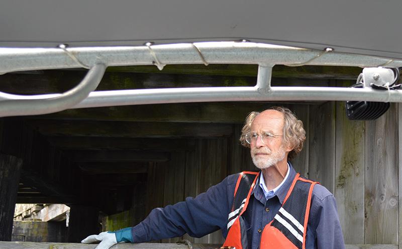 George Blomberg looks pensively out to sea on a boat en route to Smith Cove