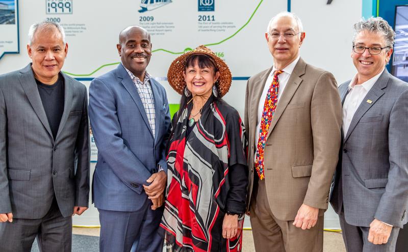 Lance Lyttle, Luis Navarro and Fred Felleman pose with members of the United Indians of All Tribes Foundation, owners of Sacred Circle at Sea-Tac Airport.