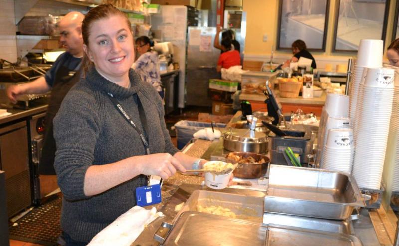Beechers Cheese employee scooping macaroni and cheese