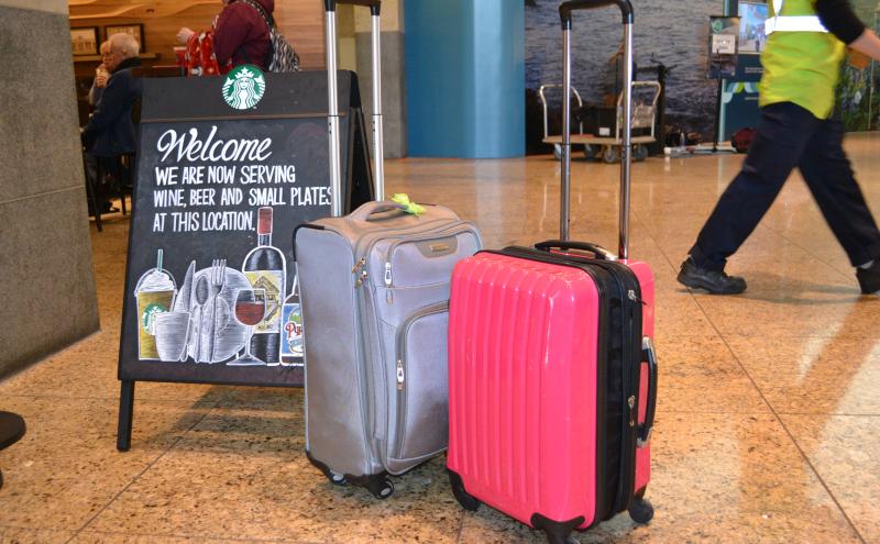Suitcases in front of a Starbucks store.