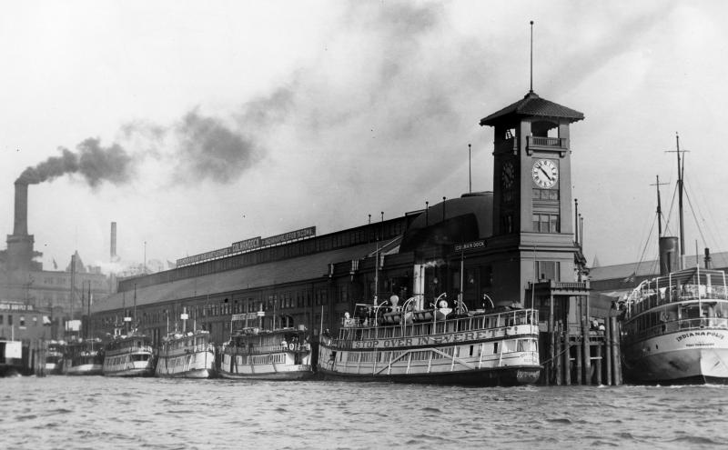 Vessels of the Mosquito Fleet, primary conveyances for travel throughout the Puget Sound Region in the 1180-1890s, take every foot of space at Colman Dock.