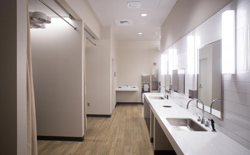 Multi-user nursing suite with sinks and large counter space across from private rooms.