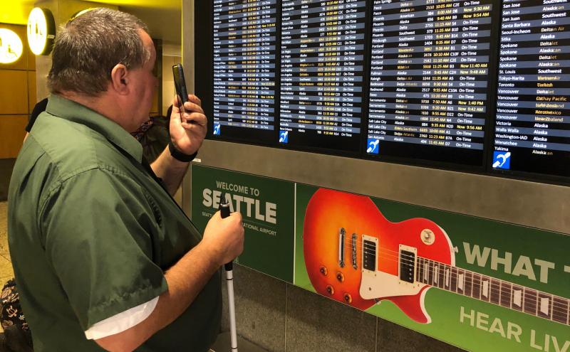 Larry Watkinson uses Aira assistive technology to help him navigate SEA.