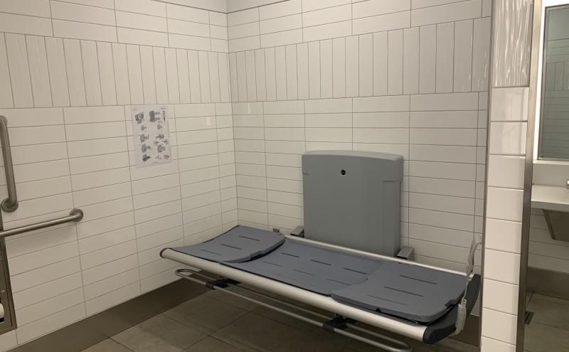 Adult changing table in upgraded SEA family restroom