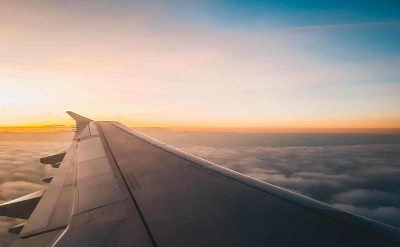 View of an airplane wing at sunrise