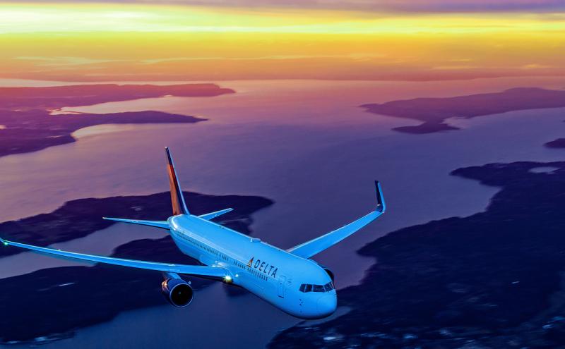 Delta aircraft over land with a sunset. Photo courtesy of Delta Airlines, 2017