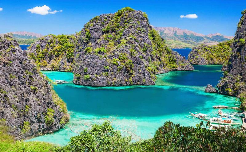 Beautiful crystal blue waters surround multiple bulbous islands of Palawan, Philippines forming a lovely lagoon of aqua and deep turquoise 
