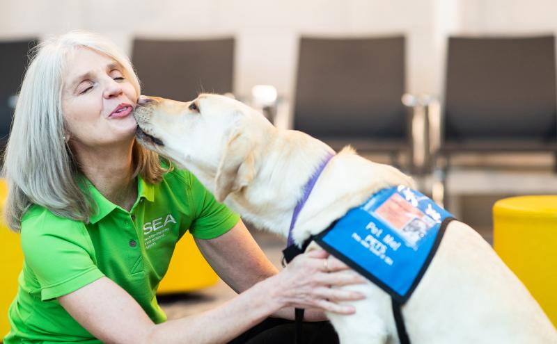 Airport volunteer Joanne Montzingo and therapy dog Gracie.