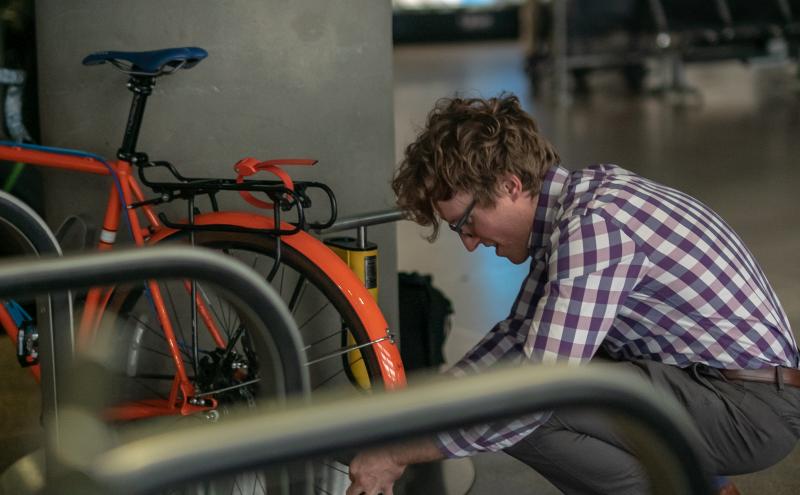Traveler securing bike on the rack.