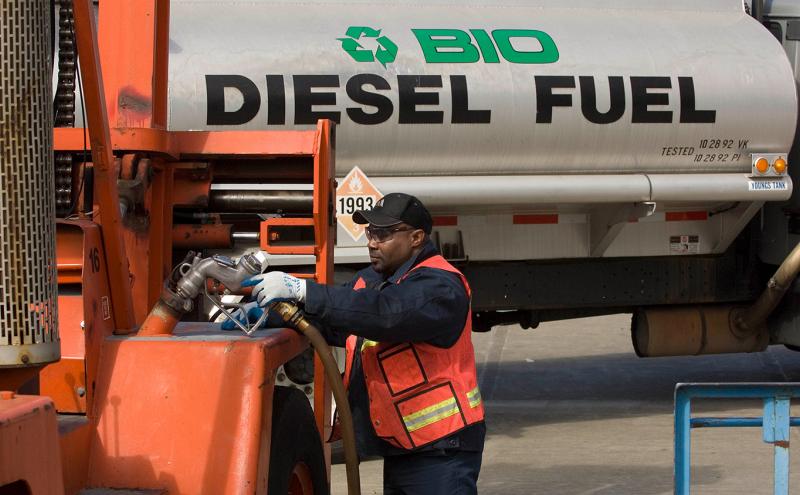 Man fills large commercial vehicle with biodiesel.
