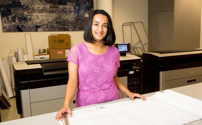 Woman looking at blueprints.