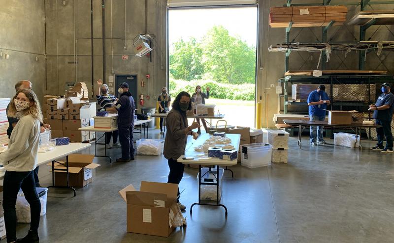 Port employees prepare face coverings for distribution.