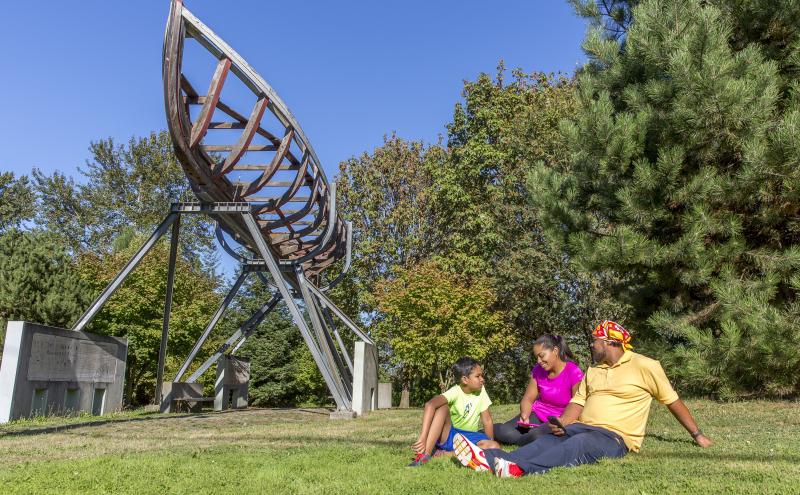Family sitting at T107 Park on a sunny day