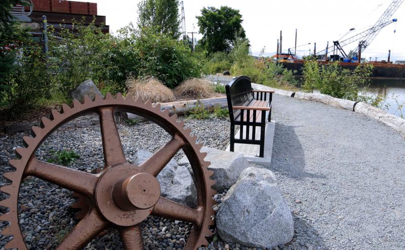 8th Avenue South Park with gears, gravel trail, and park bench