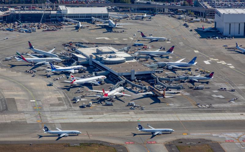 Aerial shot of South Satellite of SEA Airport with planes surrounding it. 