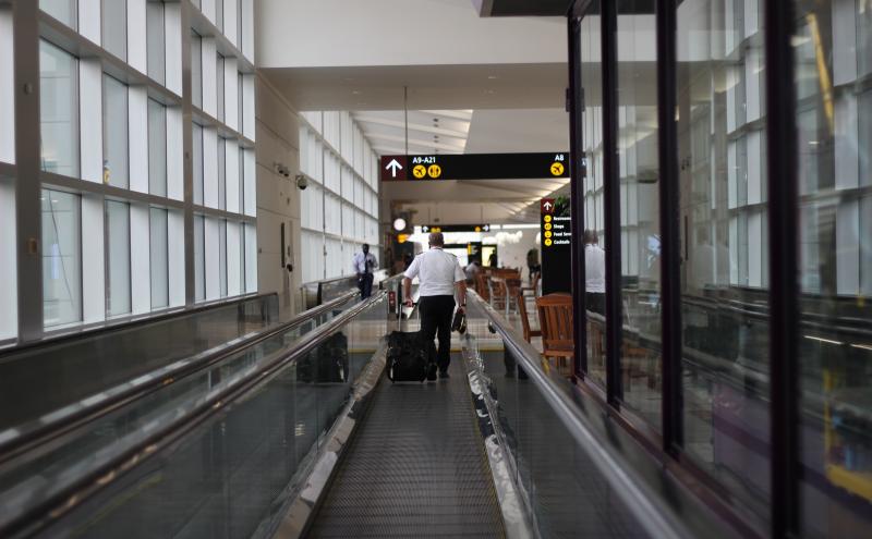 An Airport Employee on the moving walkways in A Gates