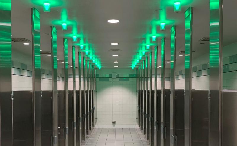 Green "Tooshlights" line the ceiling of a restroom at SEA Airport, Aug. 28, 2020