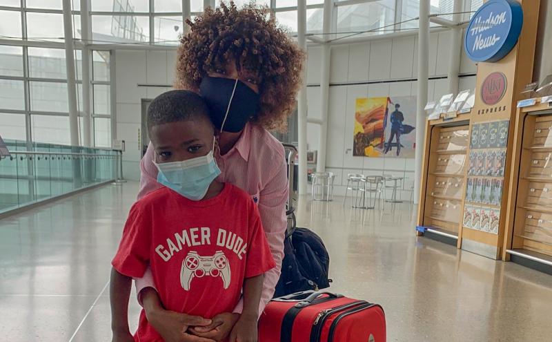 Mom and son masked up and ready to travel, SEA Airport, June, 2020