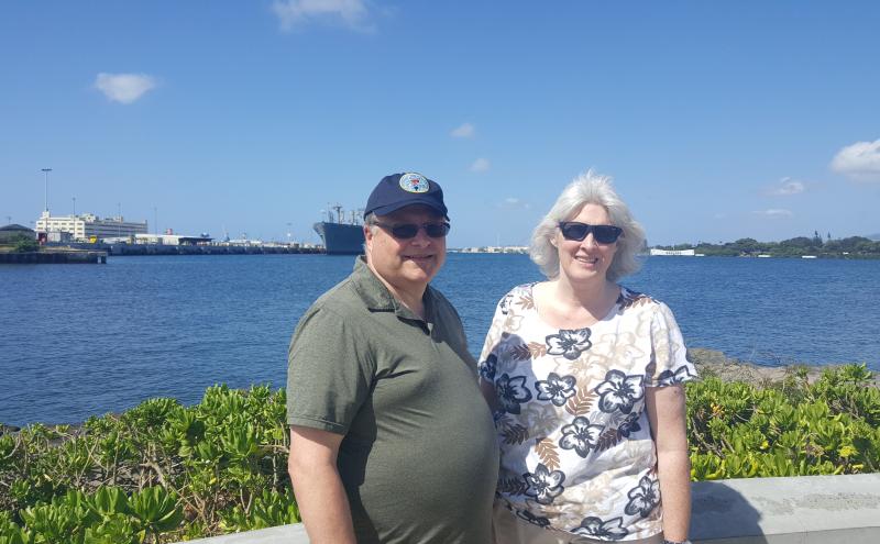 Duane Gibb and his wife standing in front of water