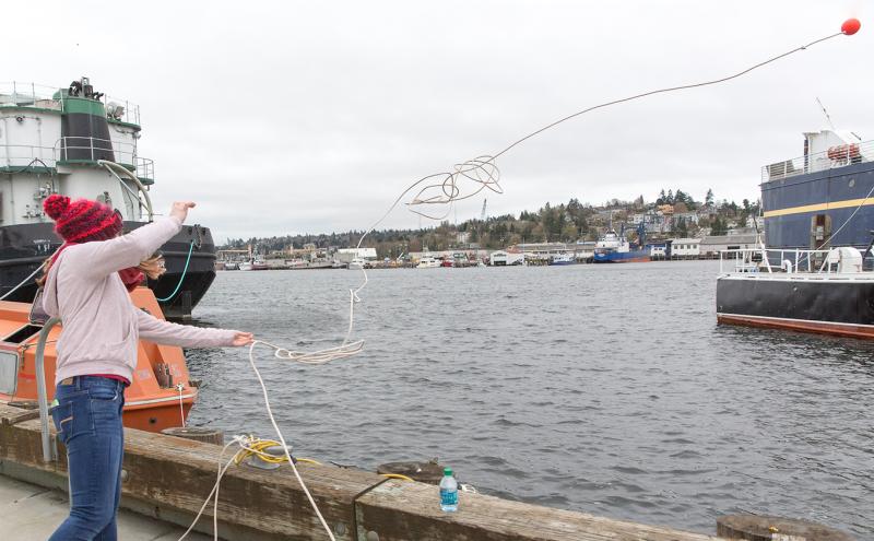 Student practices throwing a life preserver.