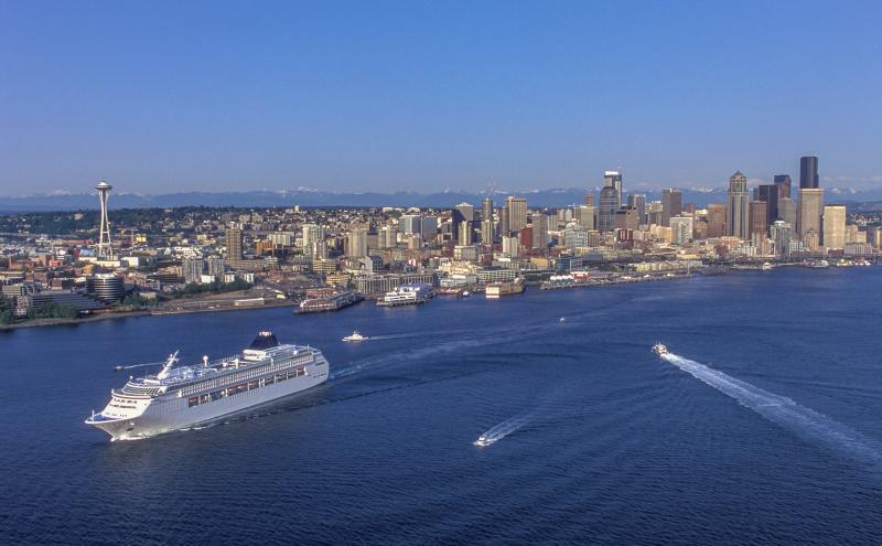 Cruise ship leaving the Port of Seattle with the skyline in the background.