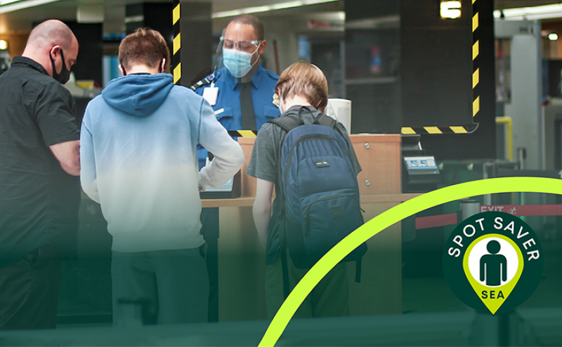 Man with two children at a security checkpoint at SEA Airport April 2021
