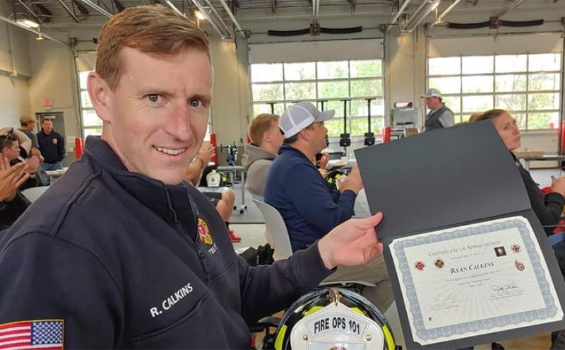 Port Commissioner Ryan Calkins shows a certificate of appreciation he received from the Fire Department.