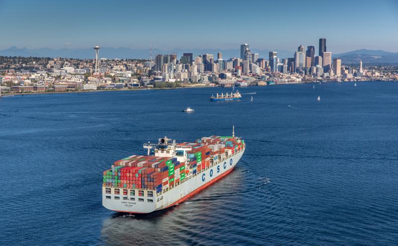 Cargo ship in Elliott Bay with the Seattle skyline in the background.