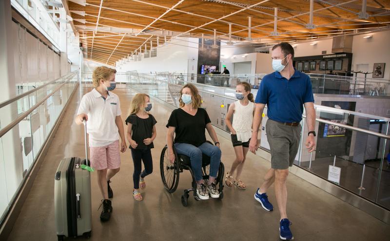 A family walks through SEA Airport