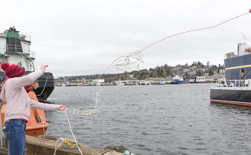 Girl throwing a buoy on the Ballard waterfront
