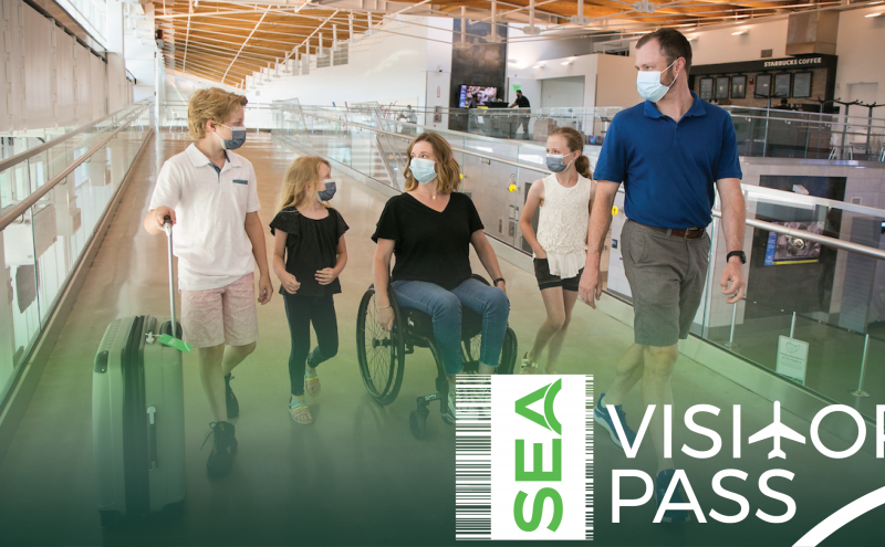 A family in masks at the airport with the SEA Visitor Pass Logo