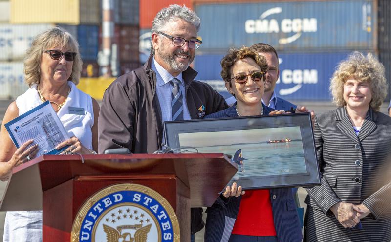 Commissioner Felleman presents Deputy Secretary Trottenberg with a photo he took of an Orca in Puget Sound.