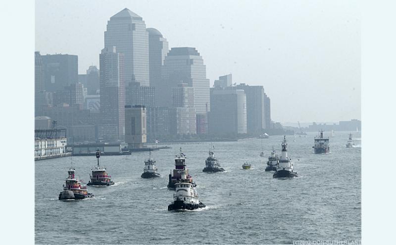 Tugboats and other craft rush to assist evacuation of people from lower Manhattan.