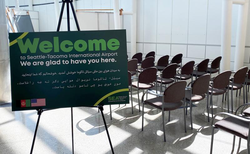 Welcom sign in English and Arabic for Afghan reguees arriving at SEA Airport Sept 8 2021