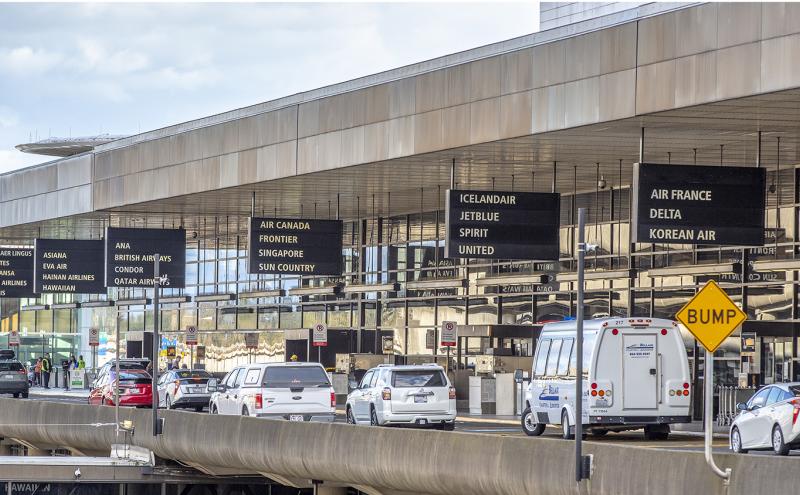 cars and shuttles on the departures drive of SEA Airport April 2021