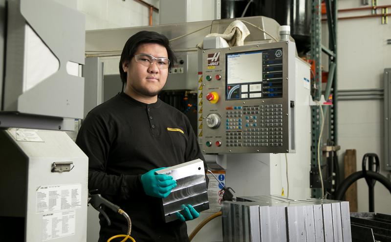 Asian man in an industrial setting at Oppenheimer Camera August 2021
