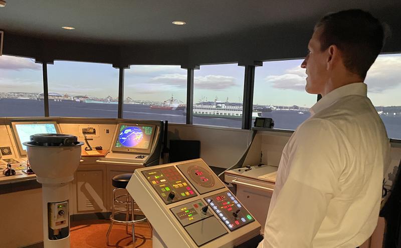 Commissioner Ryan Calkins on the vessel piloting simulator at the Maritime Institute of Tech. and Grad Studies.