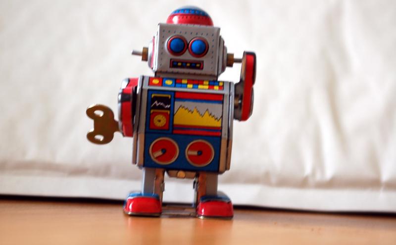 Red tin vintage toy robot with wind up key