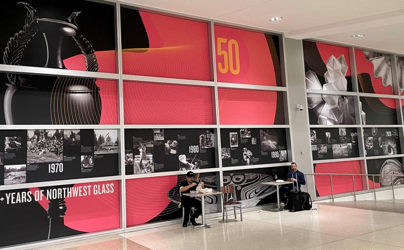 Red and black vinyl covering on windows at SEA promoting 50 year anniversary of of Pilchuck Glass School