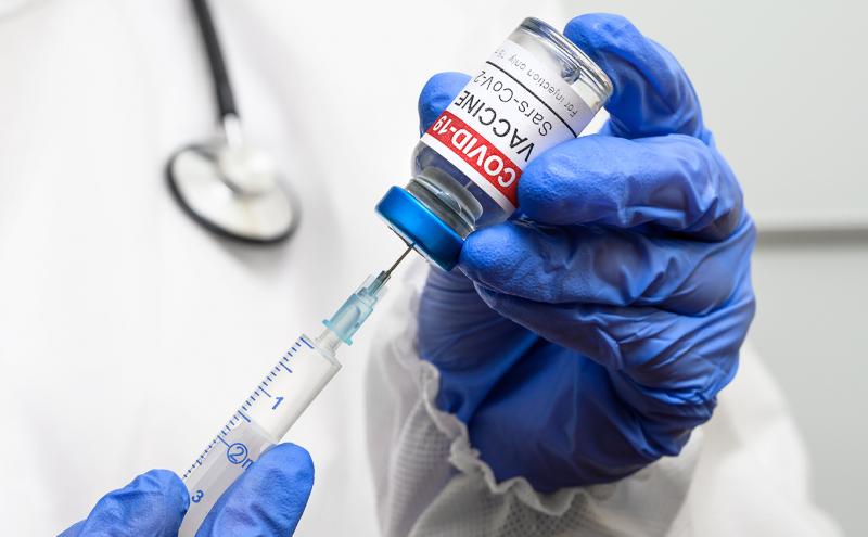 Doctor dispensing COVID-19 vaccine