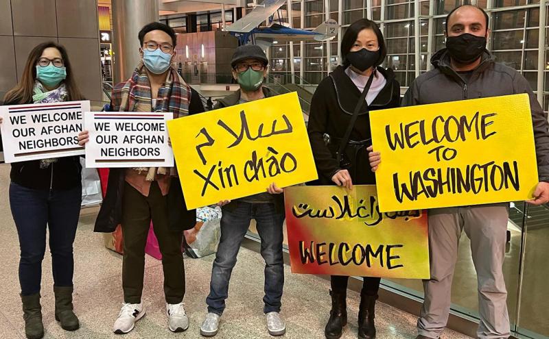 Ghulam Mohmand and Mina Le, along with other members of Viets for Afghans, wait at the airport to pick up their sponsor refugee family.